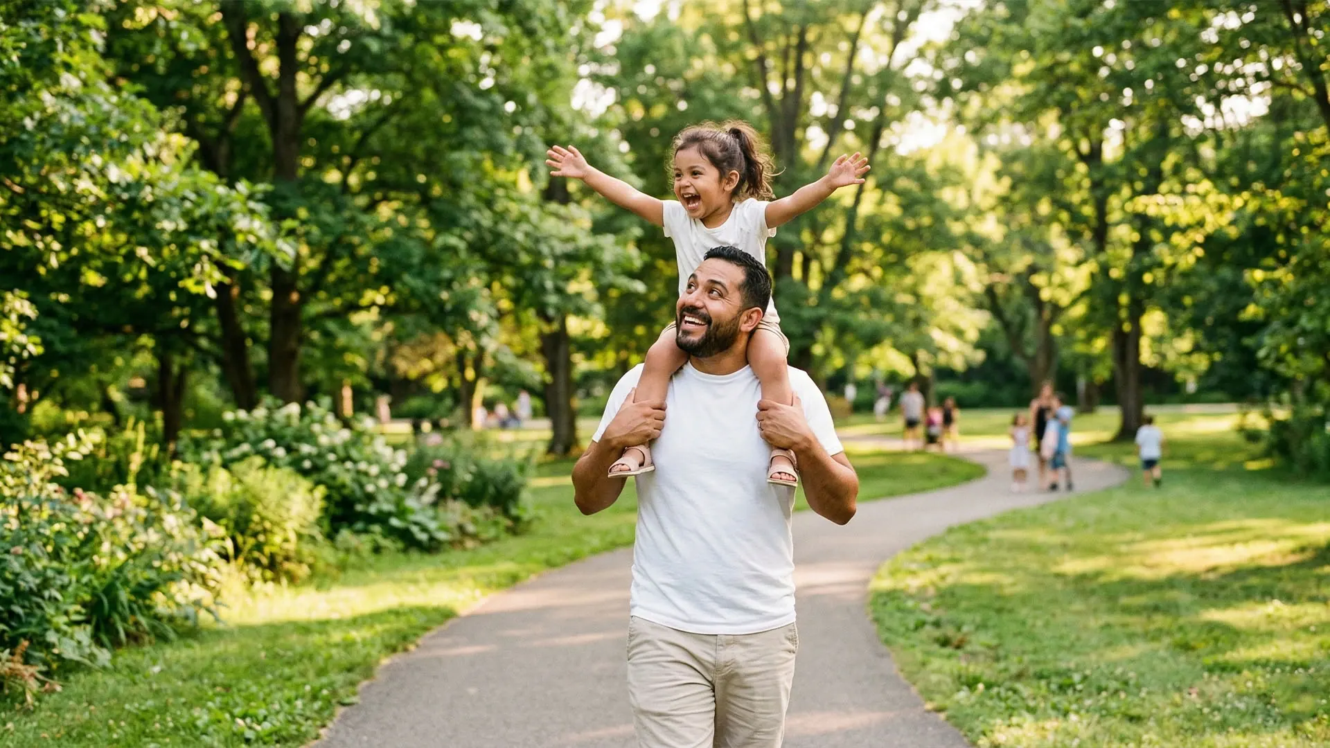 Father carrying his young daughter on his shoulders outdoors